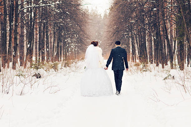 bride and groom in the winter woods.
